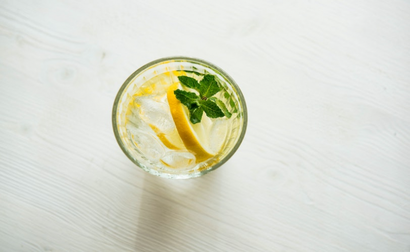 A glass of water with a slice of lemon
